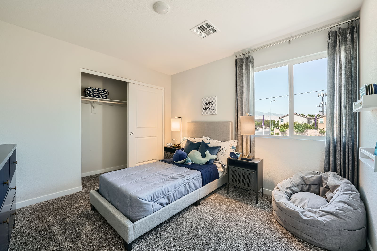 A bedroom with a large window.