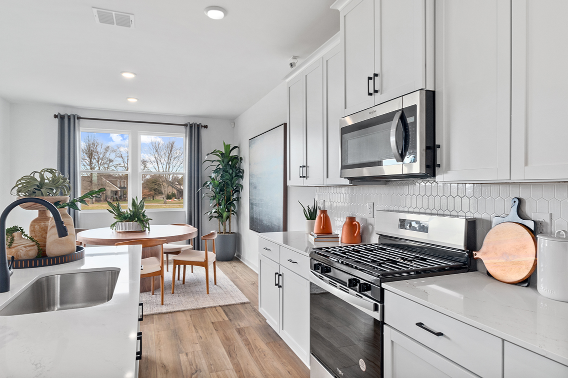 A kitchen with white cabinets.