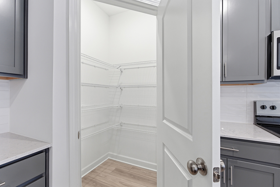 A kitchen with white cabinets.