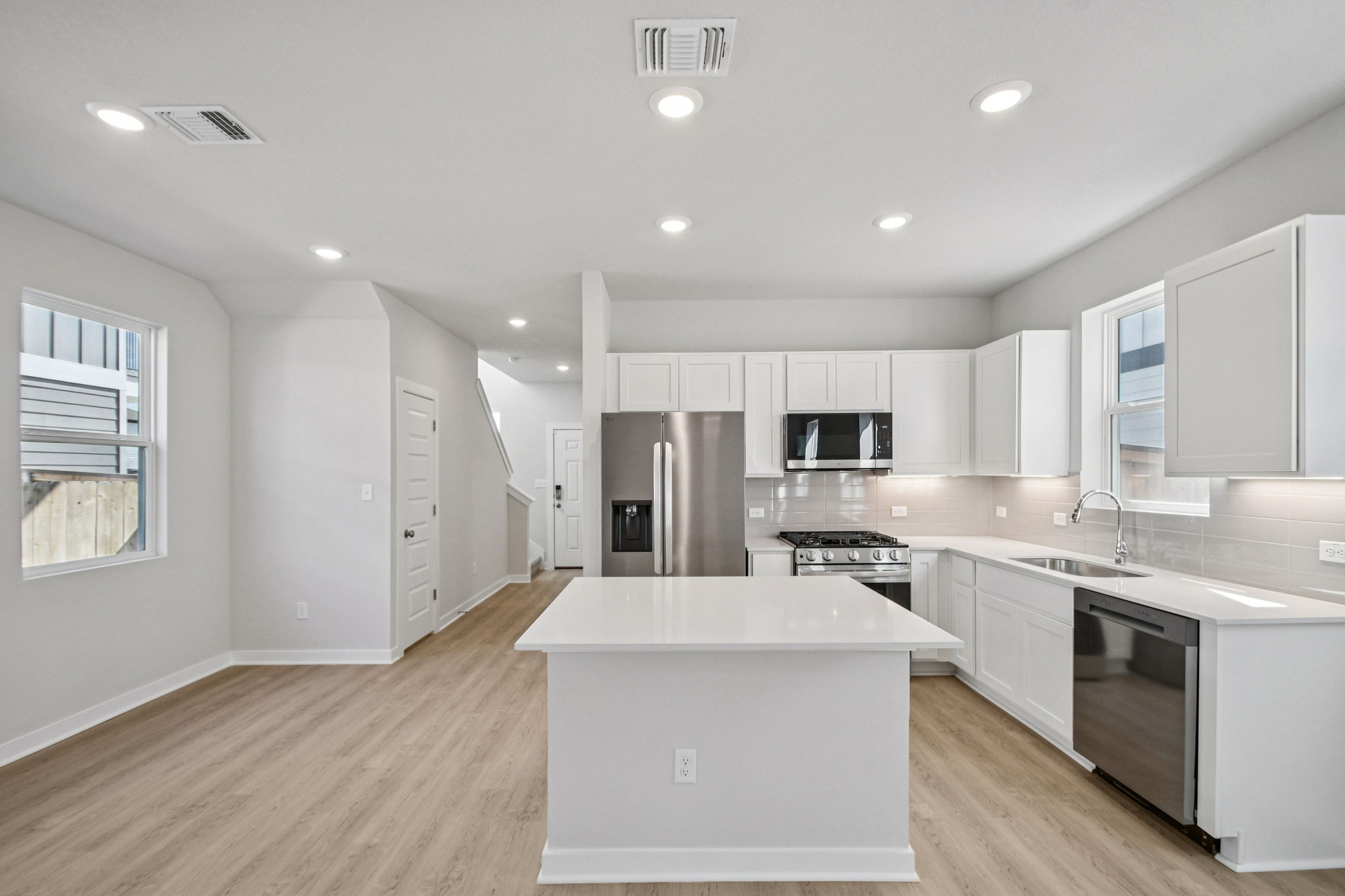 A kitchen with white cabinets.