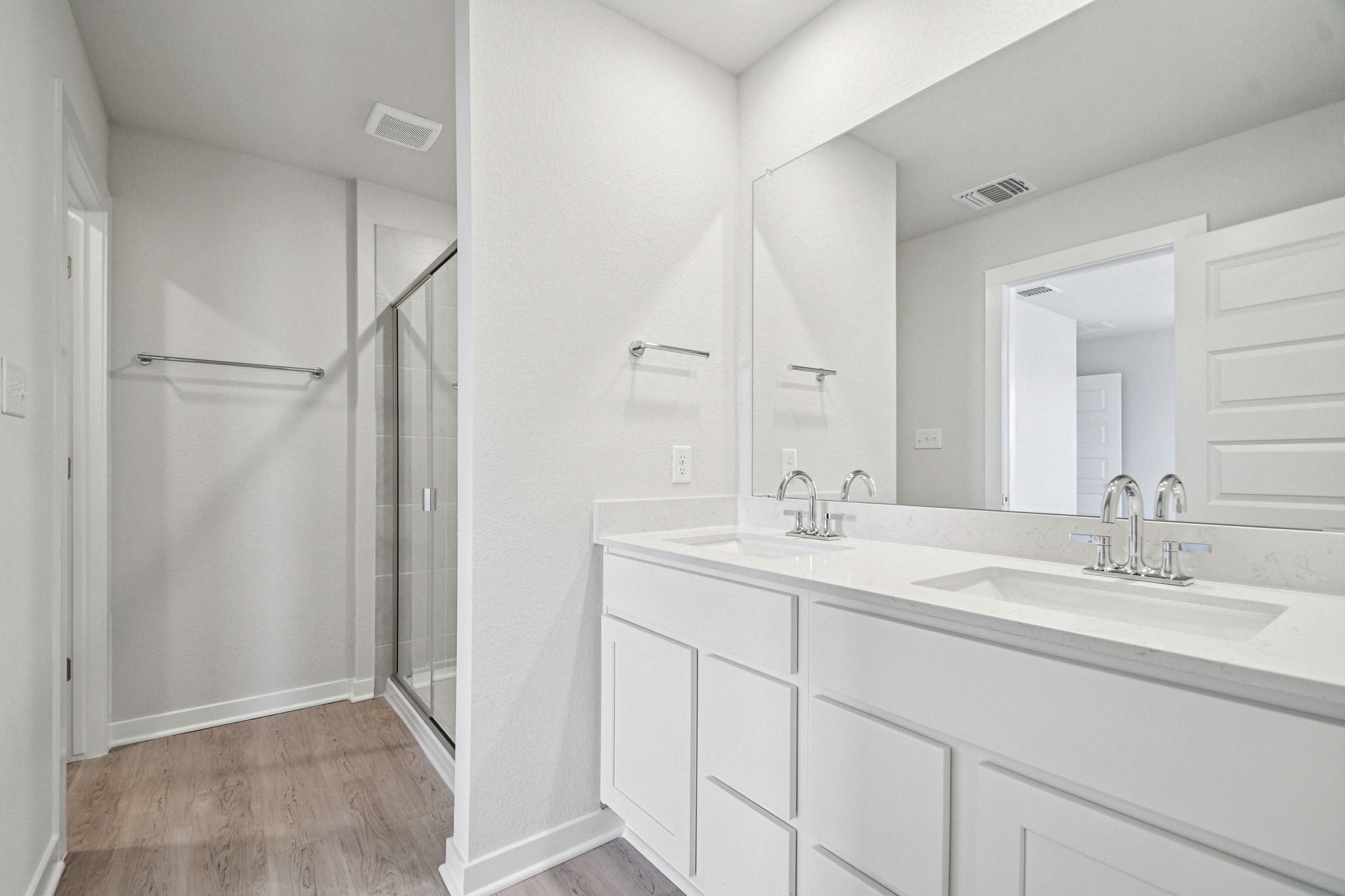 A bathroom with white cabinets.
