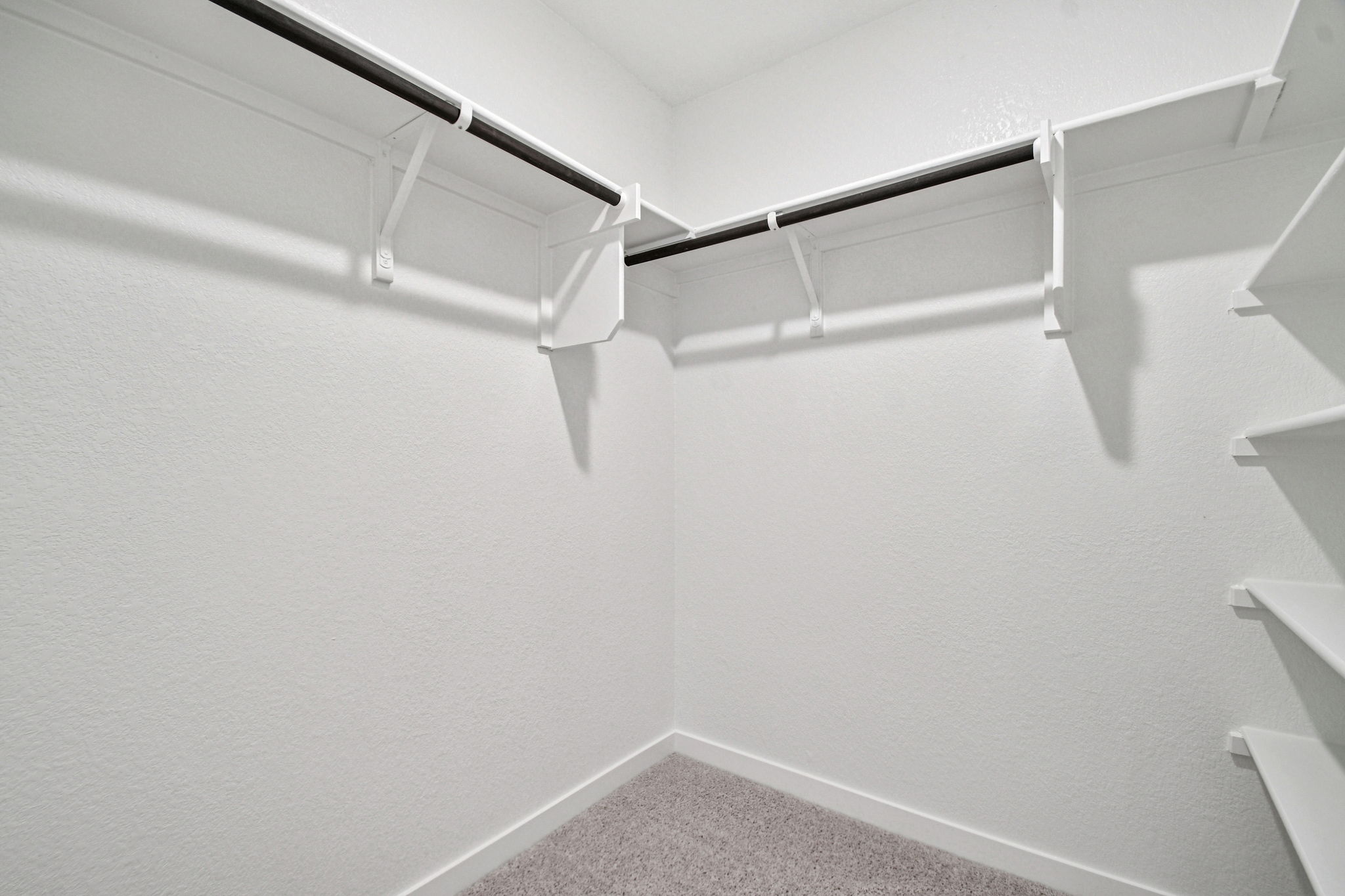 A white staircase with a white wall.