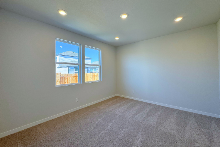 A room with a window and a carpet.