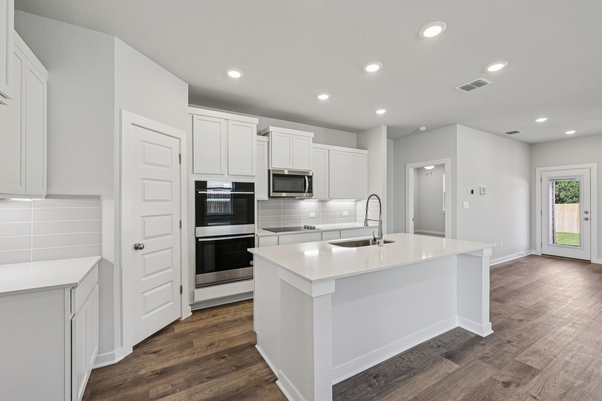 A kitchen with white cabinets.