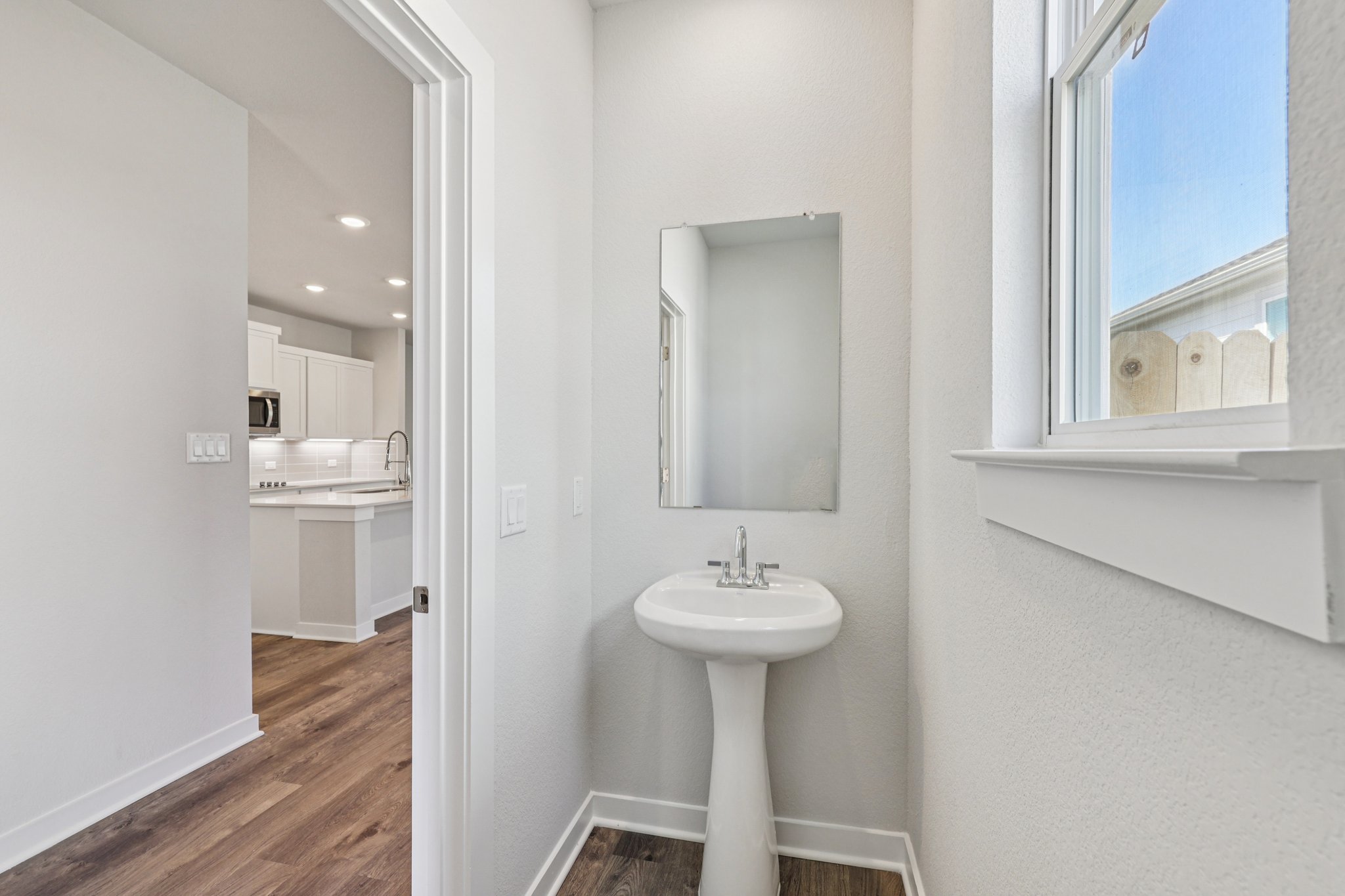 A bathroom with a sink and mirror.