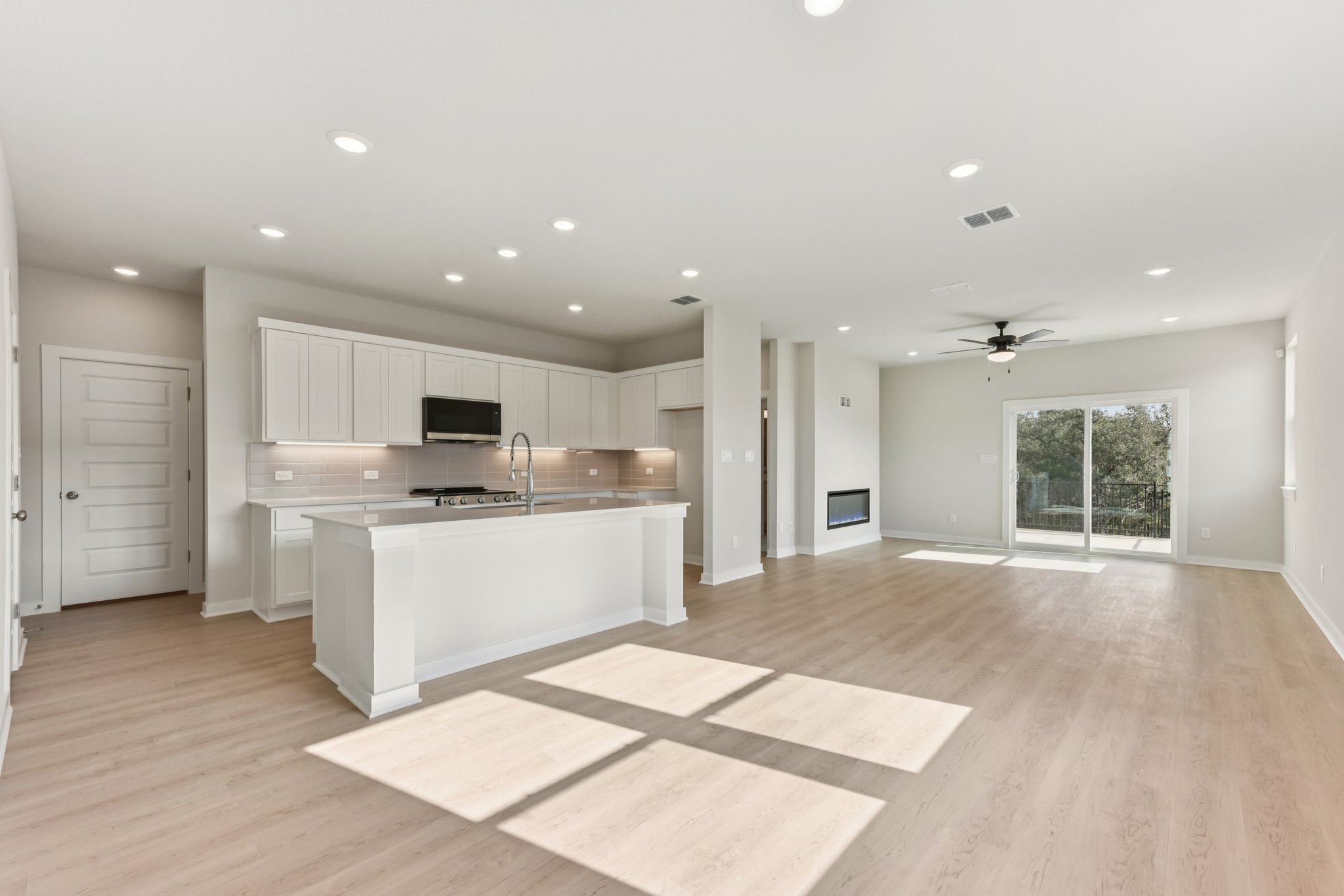 A kitchen with white cabinets.