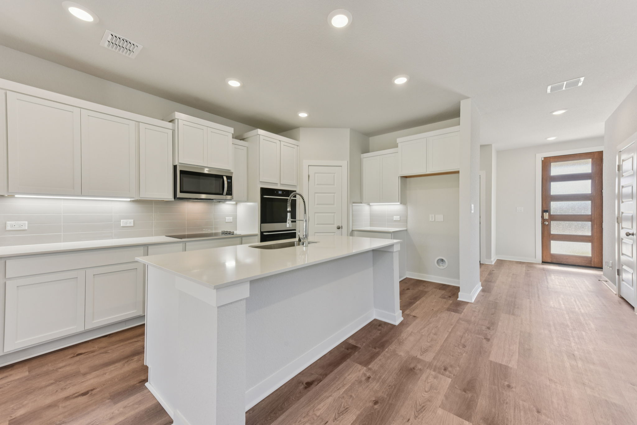 A kitchen with white cabinets.