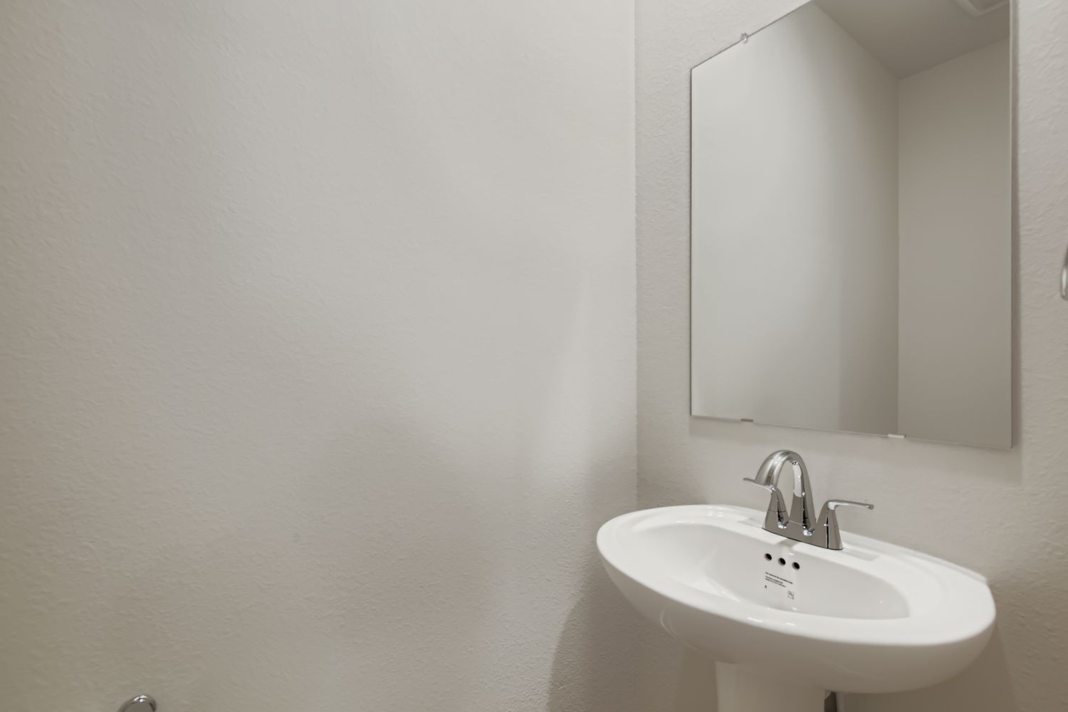 A bathroom with a mirror and sink.