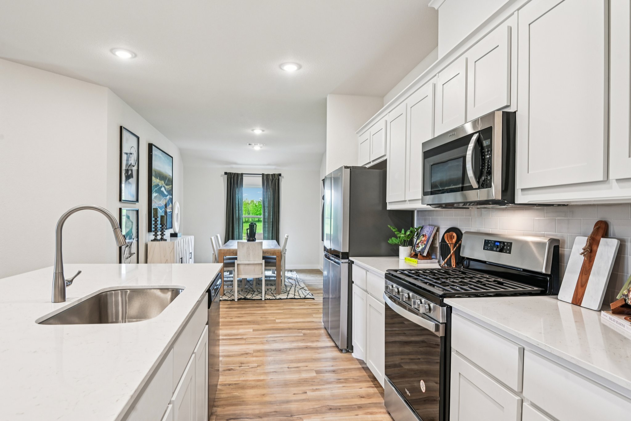 A kitchen with white cabinets.