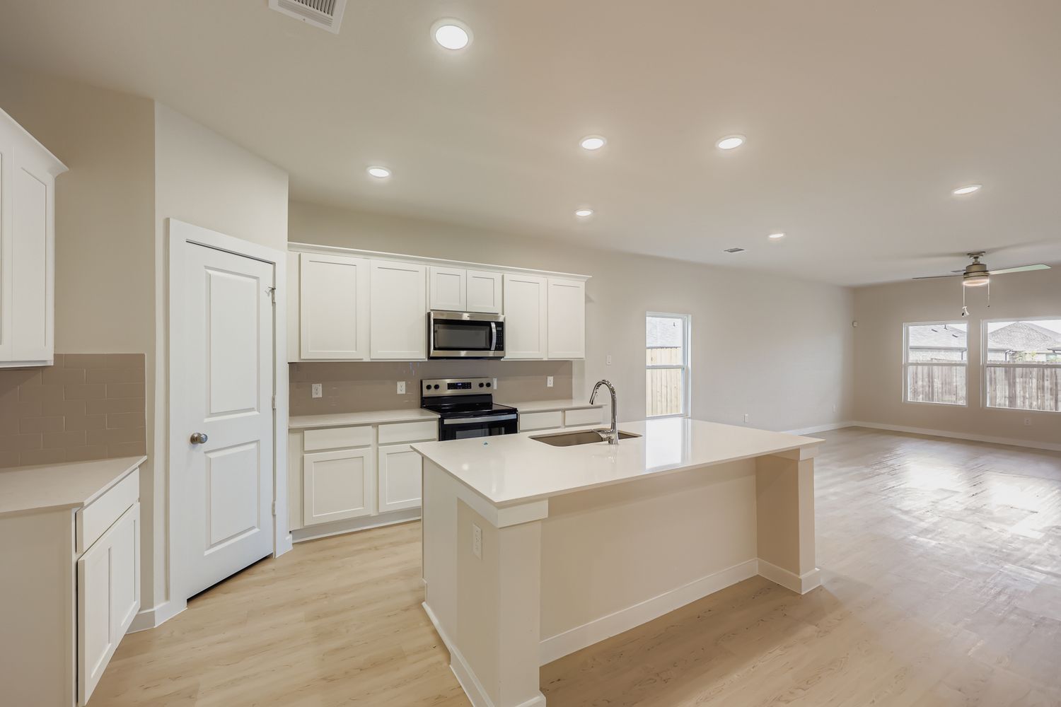 A kitchen with white cabinets.