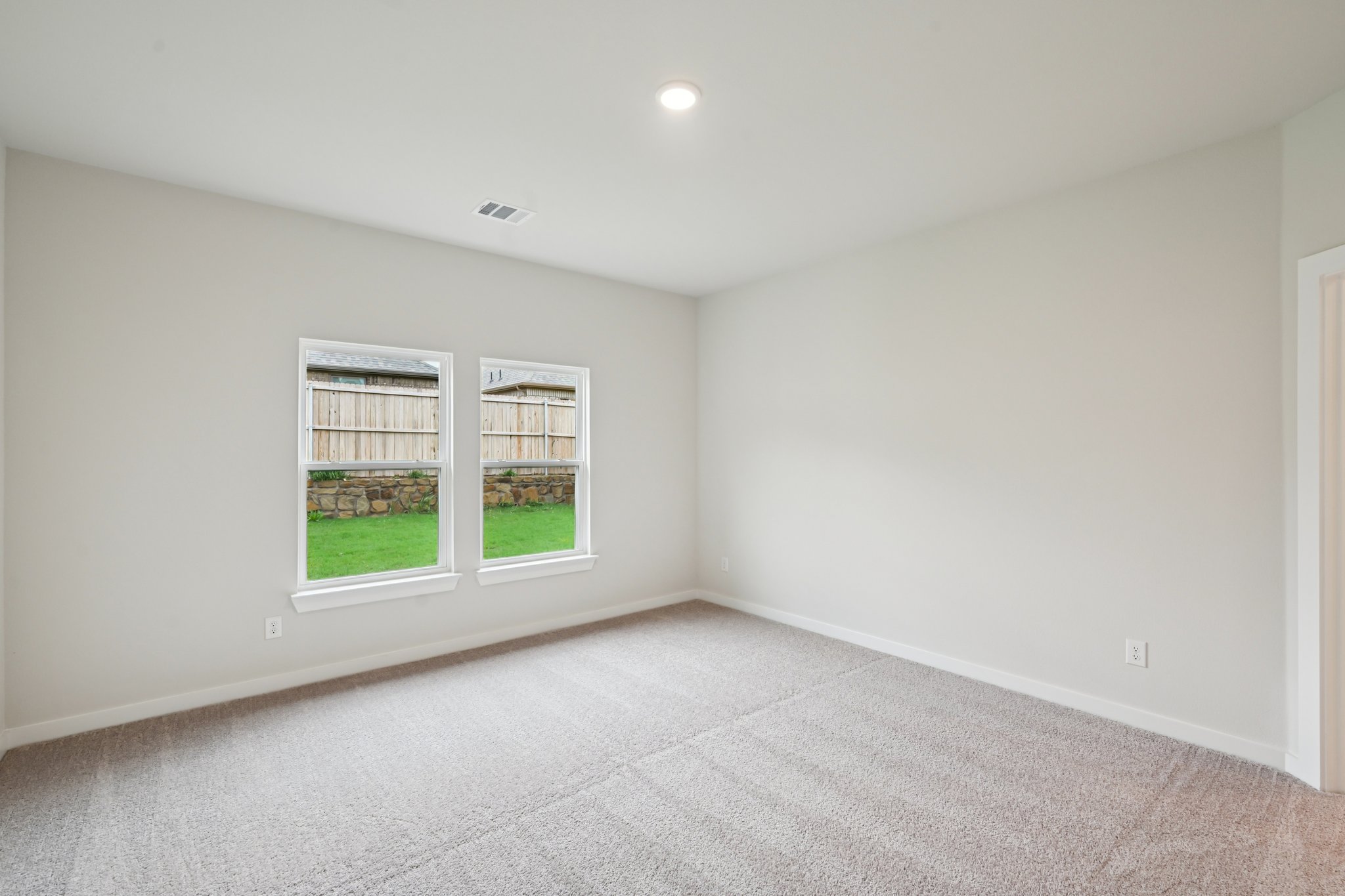 A room with a window and a door.