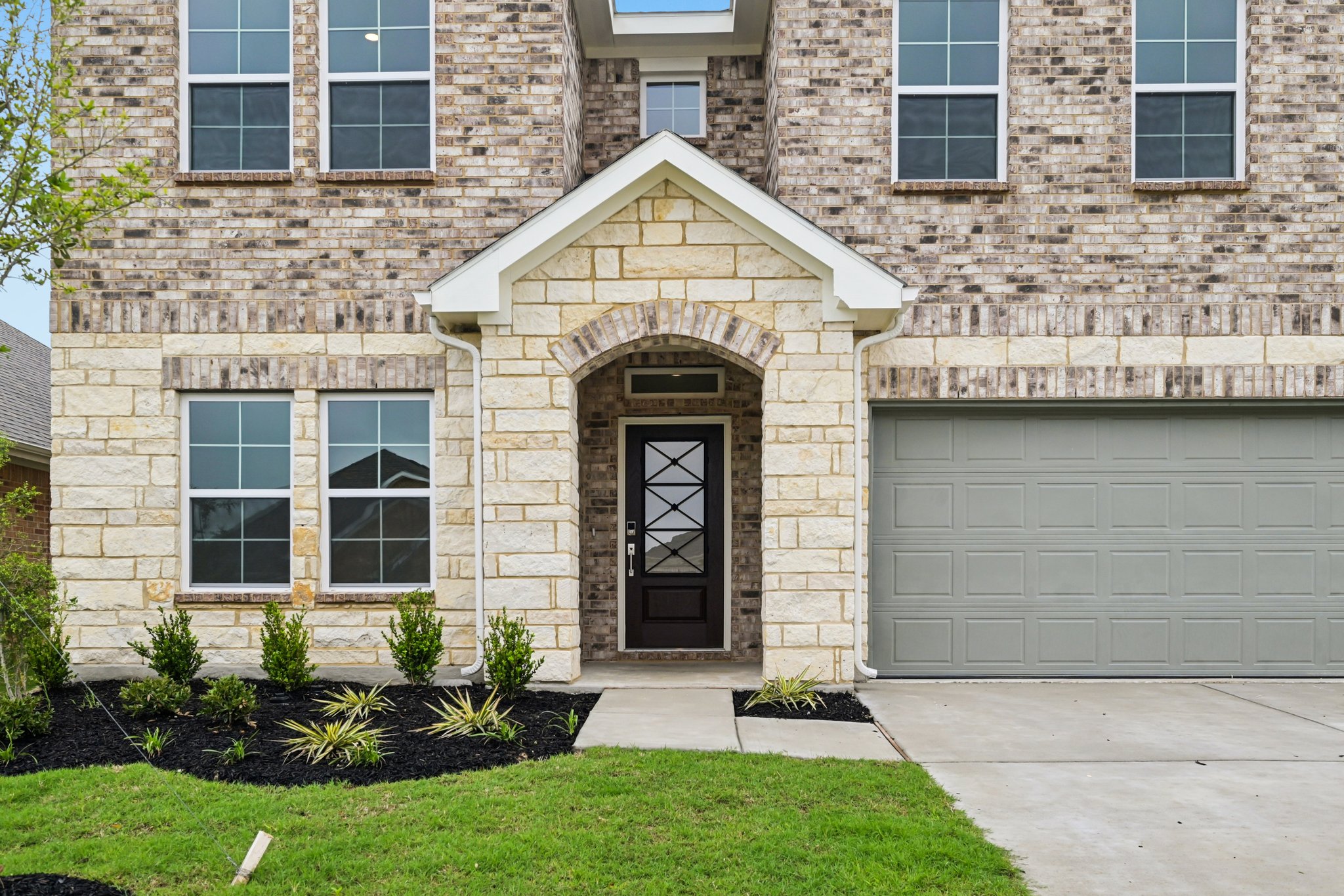 A building with a garage and a door.