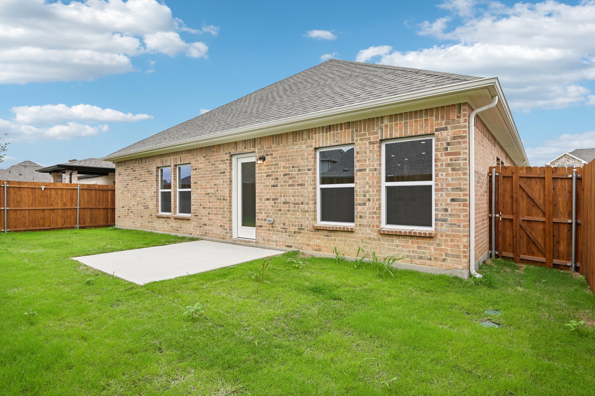 A brick house with a fence.