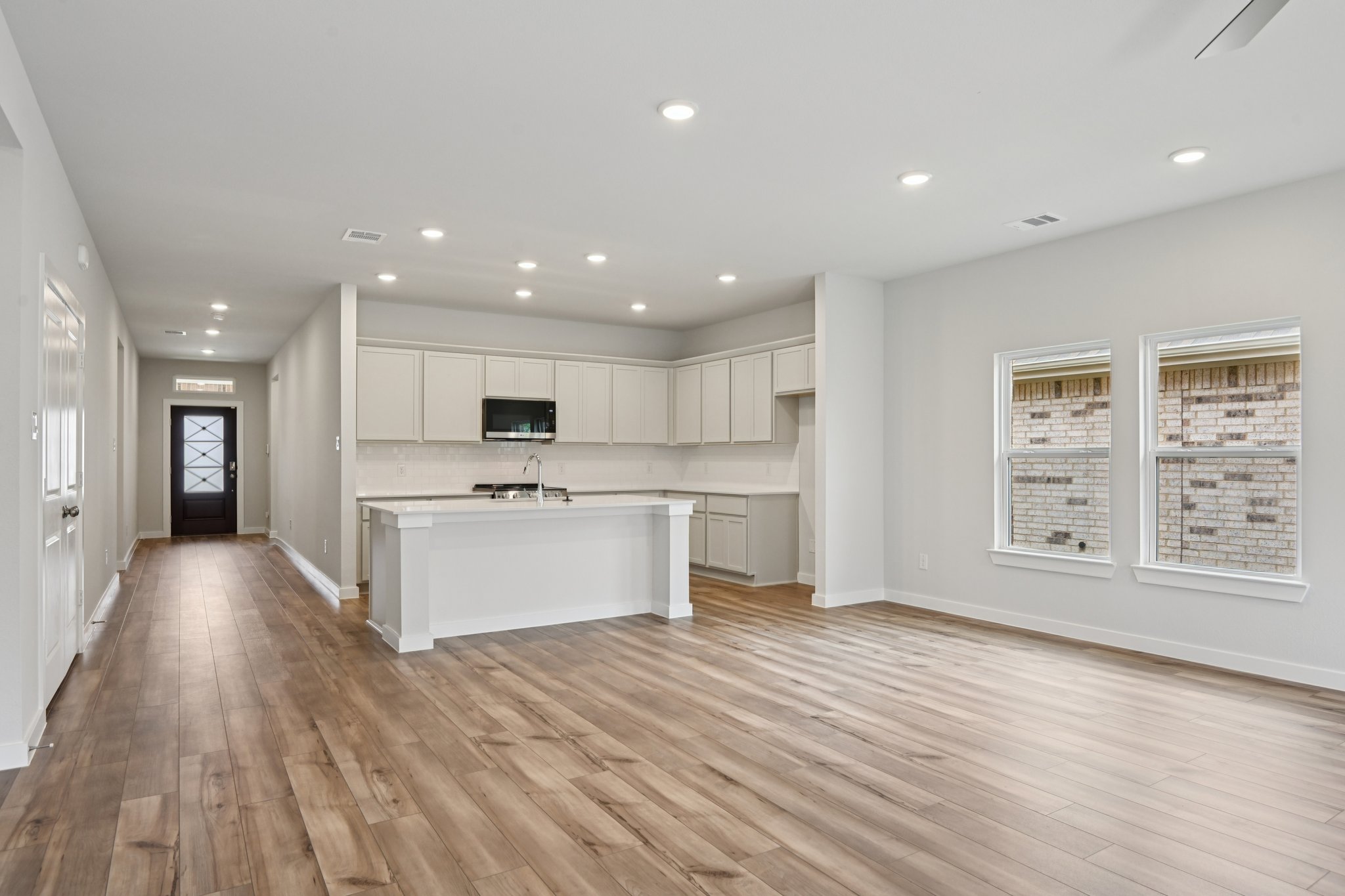 A large kitchen with white cabinets.