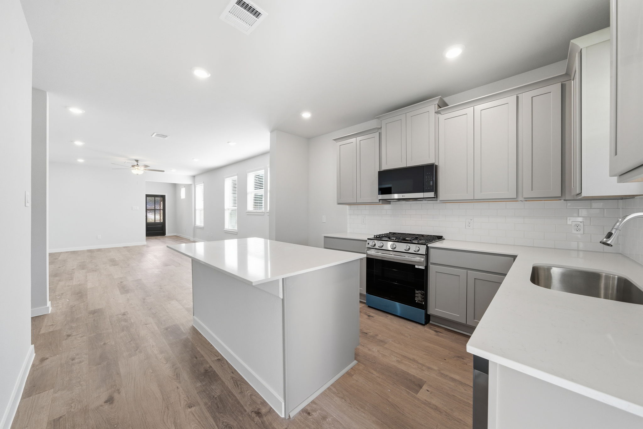 A kitchen with white cabinets.