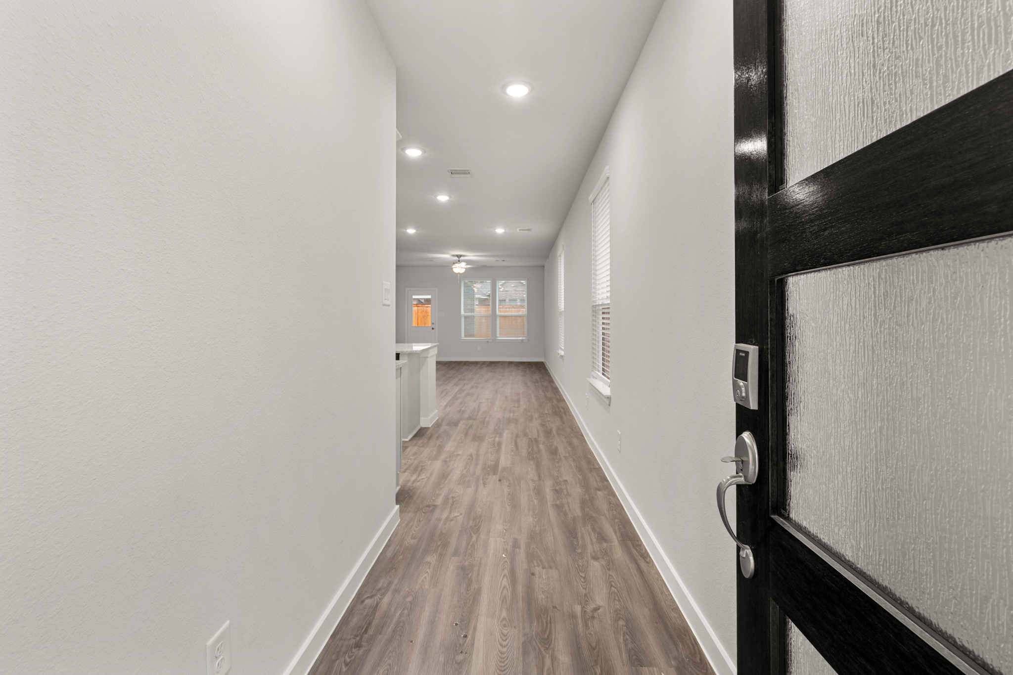 A hallway with white walls.