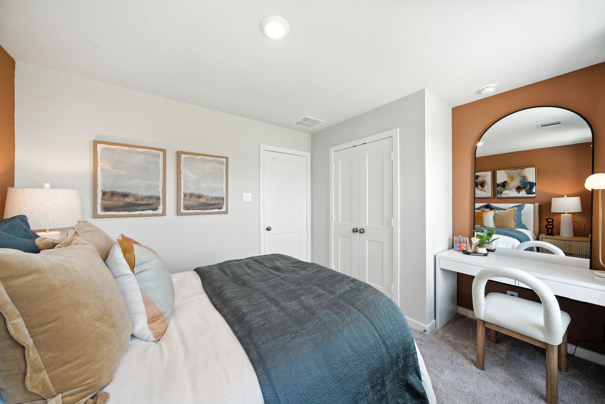 A bedroom with a bed and a desk.