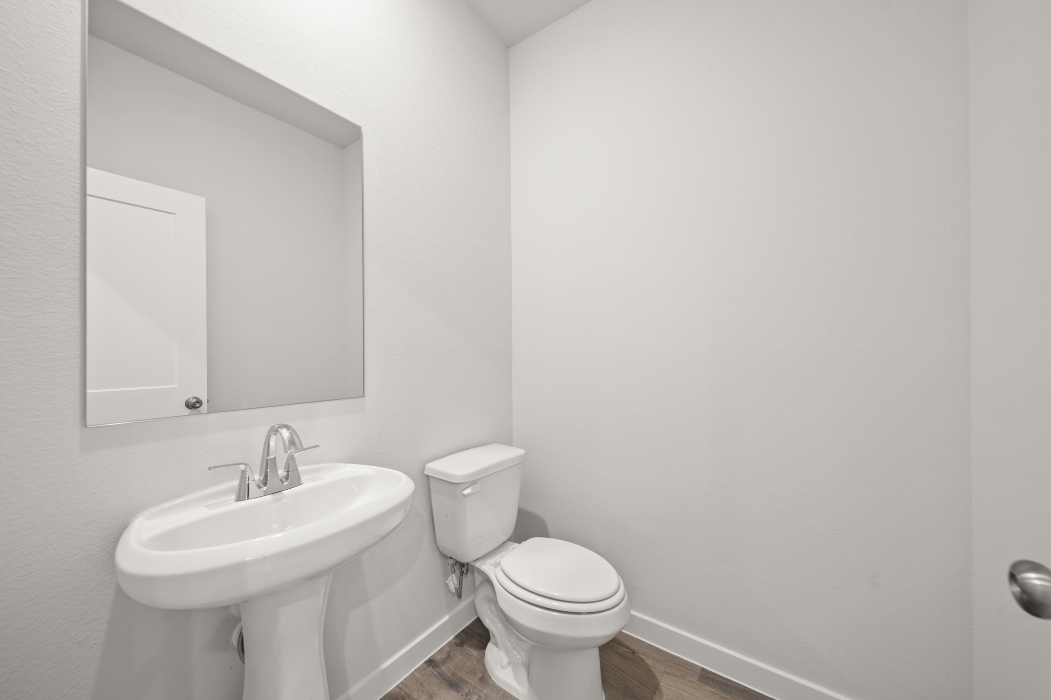 A bathroom with a toilet and sink.