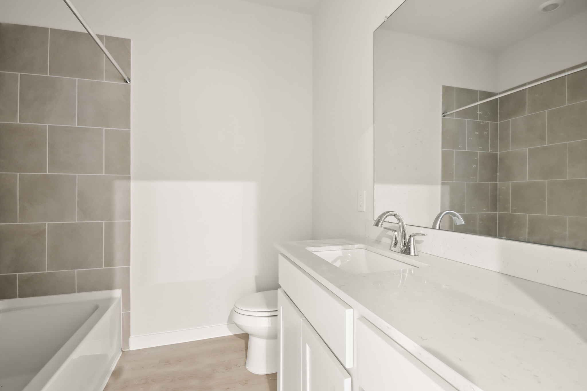 A bathroom with a tub sink and toilet.
