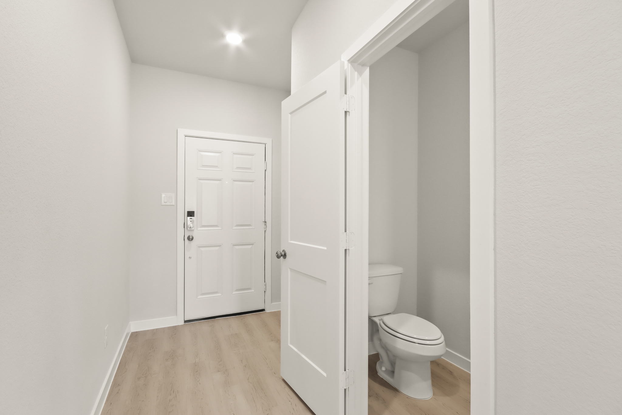 A bathroom with white doors.