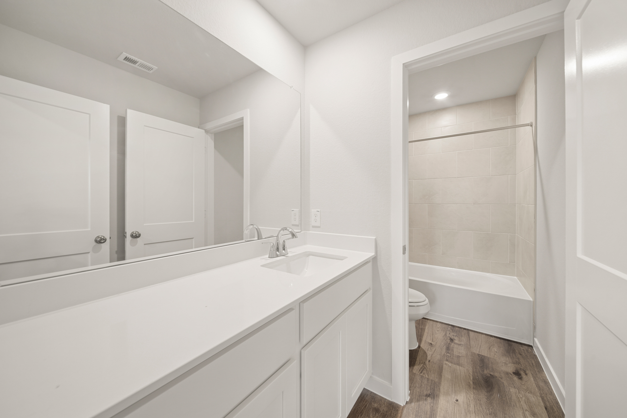 A bathroom with a tub sink and toilet.