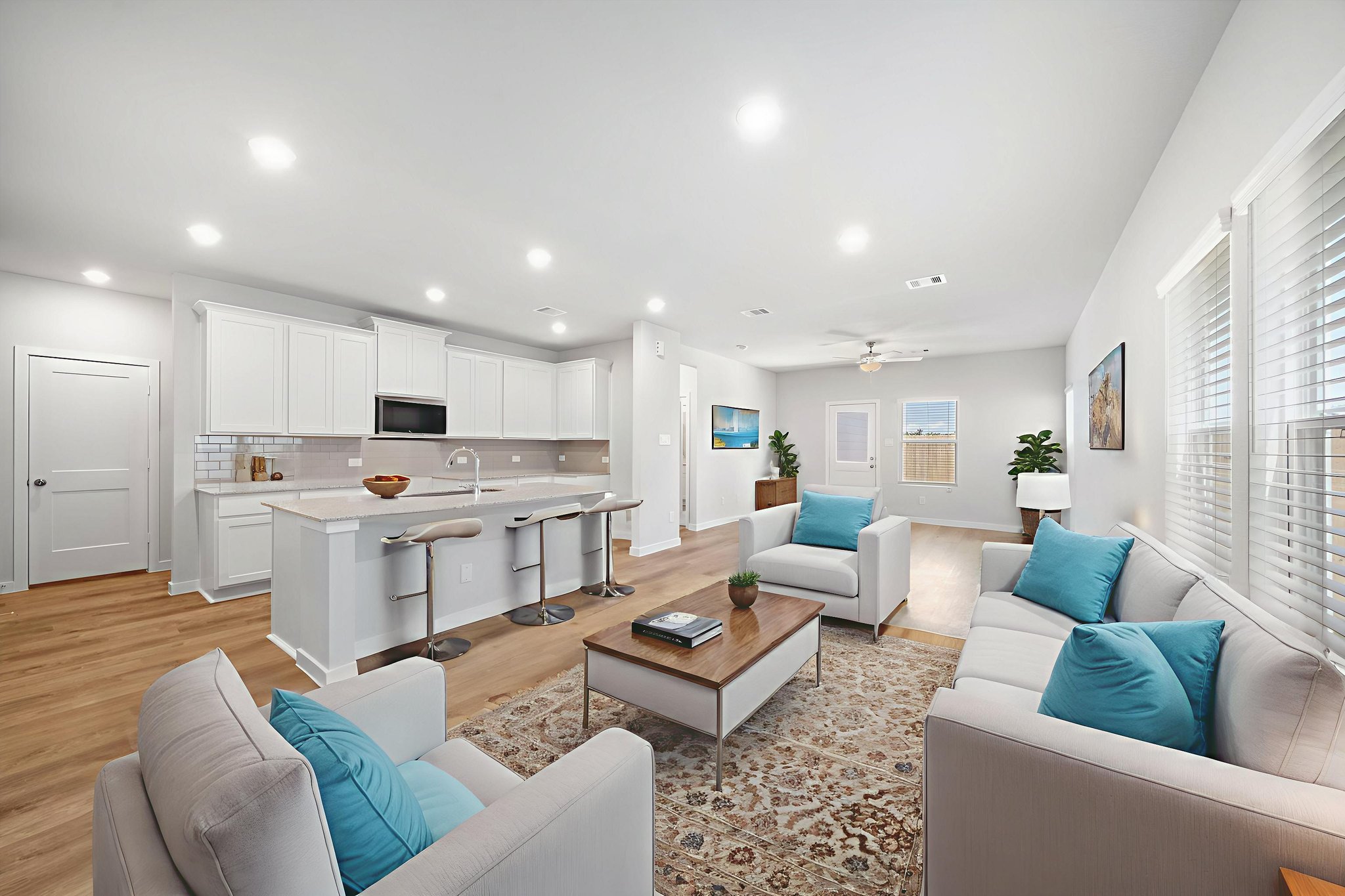 A living room with a large white couch and a table.