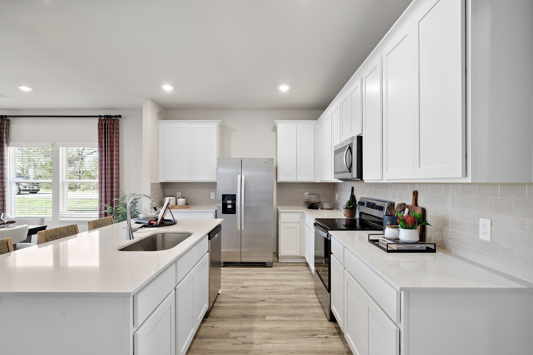 A kitchen with white cabinets.