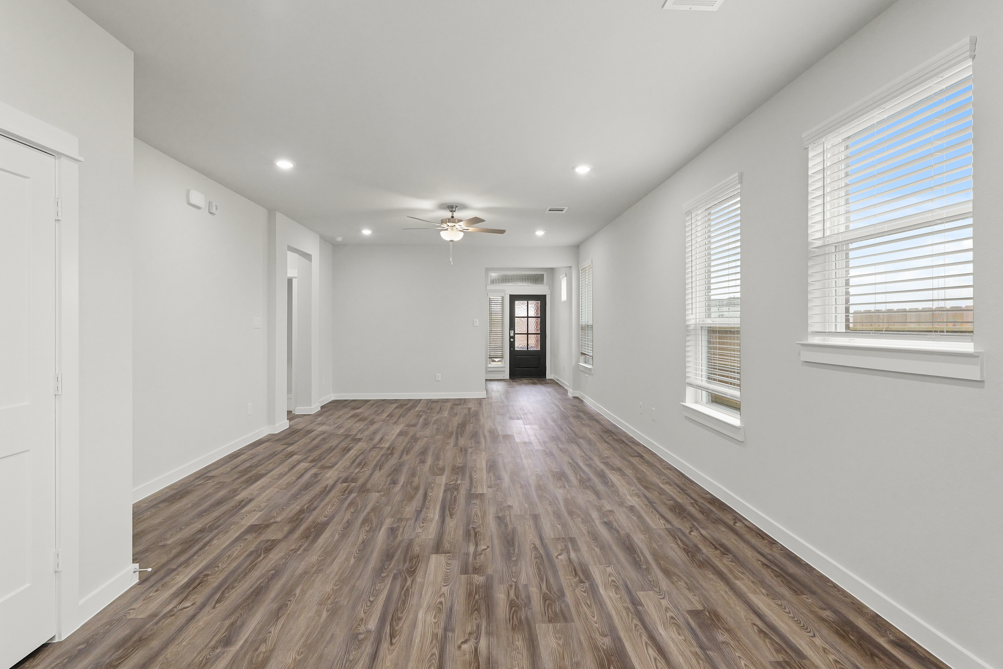 A room with a wood floor and white walls.