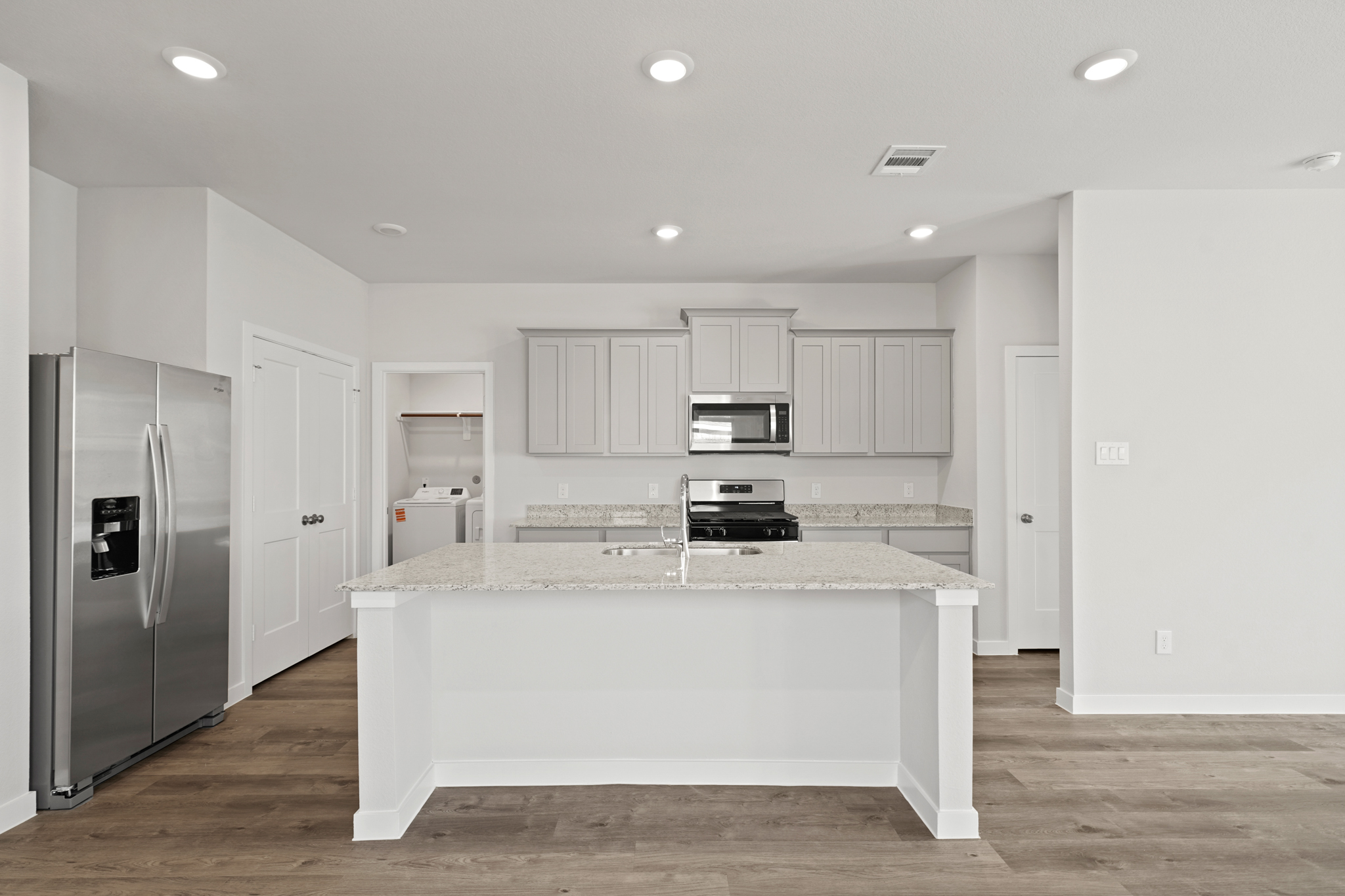 A kitchen with white cabinets.