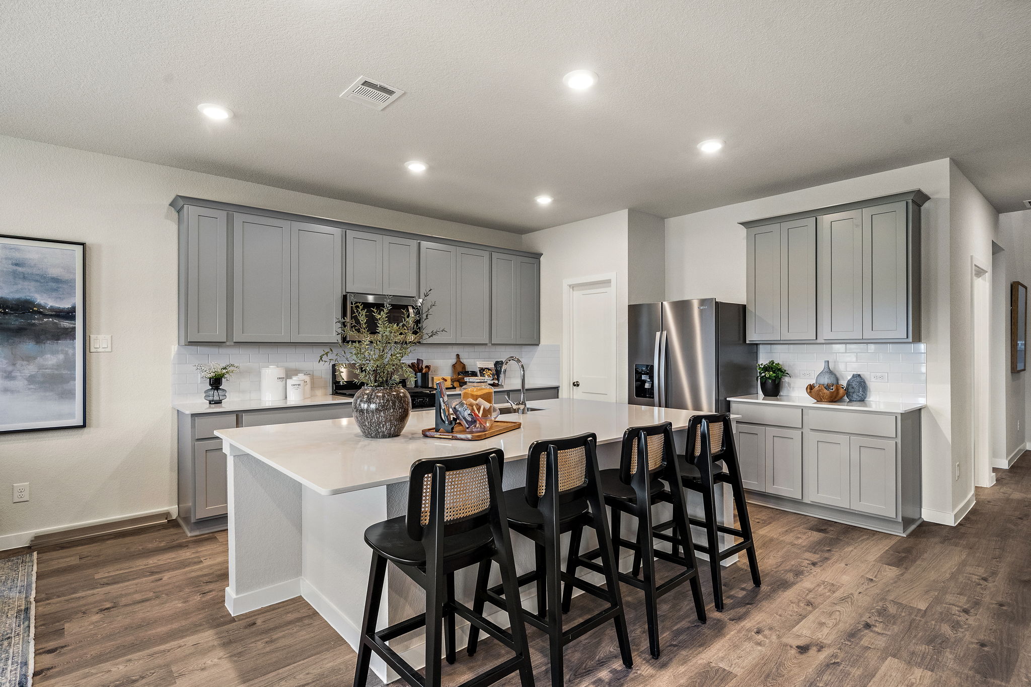 A kitchen with a dining table and chairs.