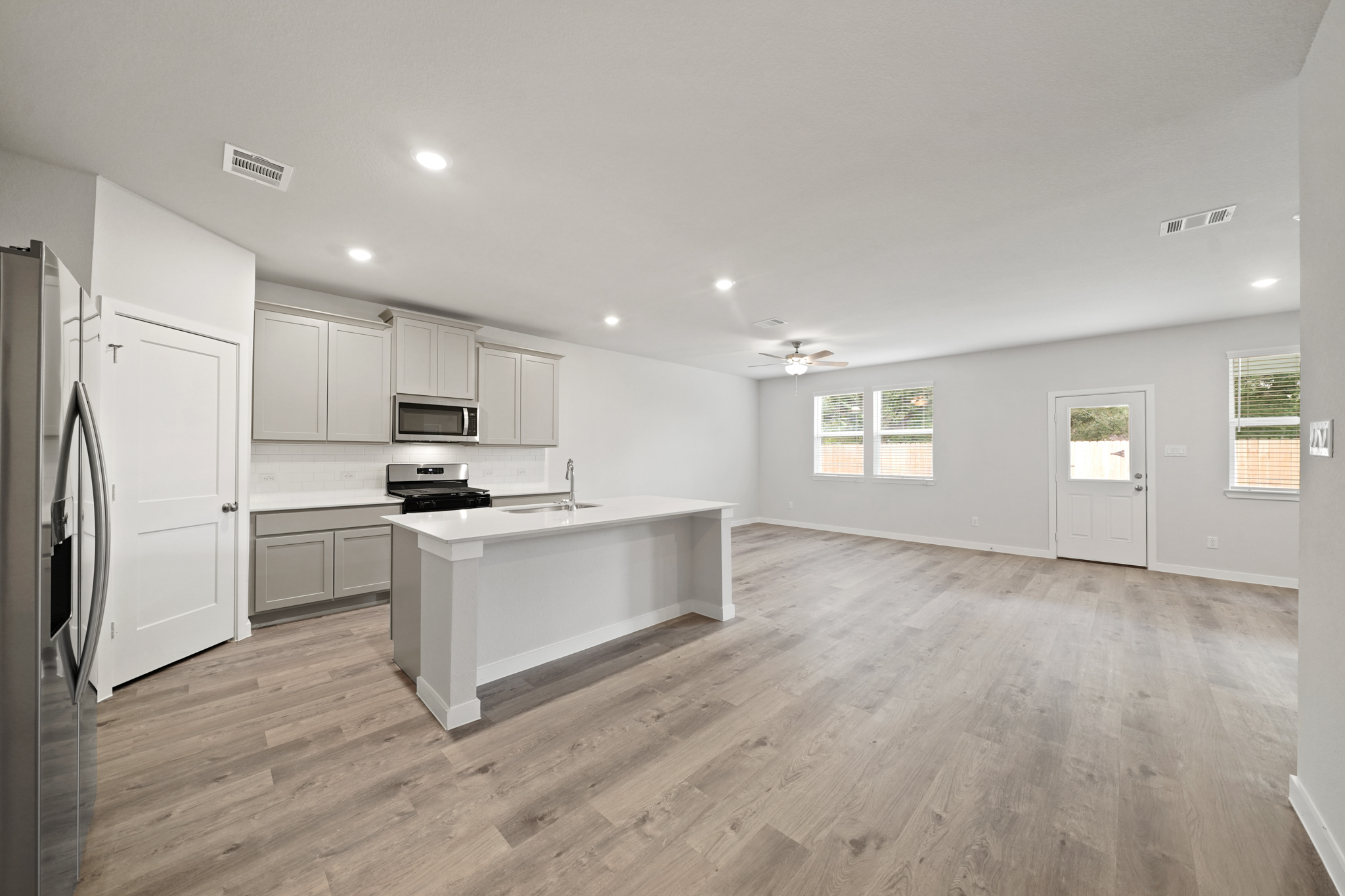 A kitchen with white cabinets.