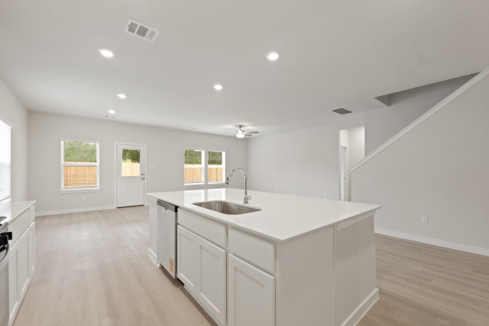 A kitchen with white cabinets.