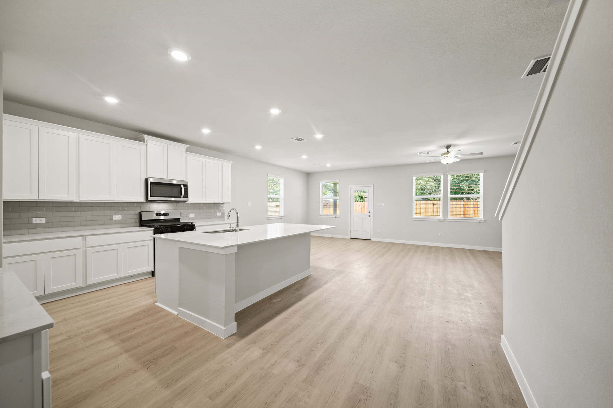 A large kitchen with white cabinets.
