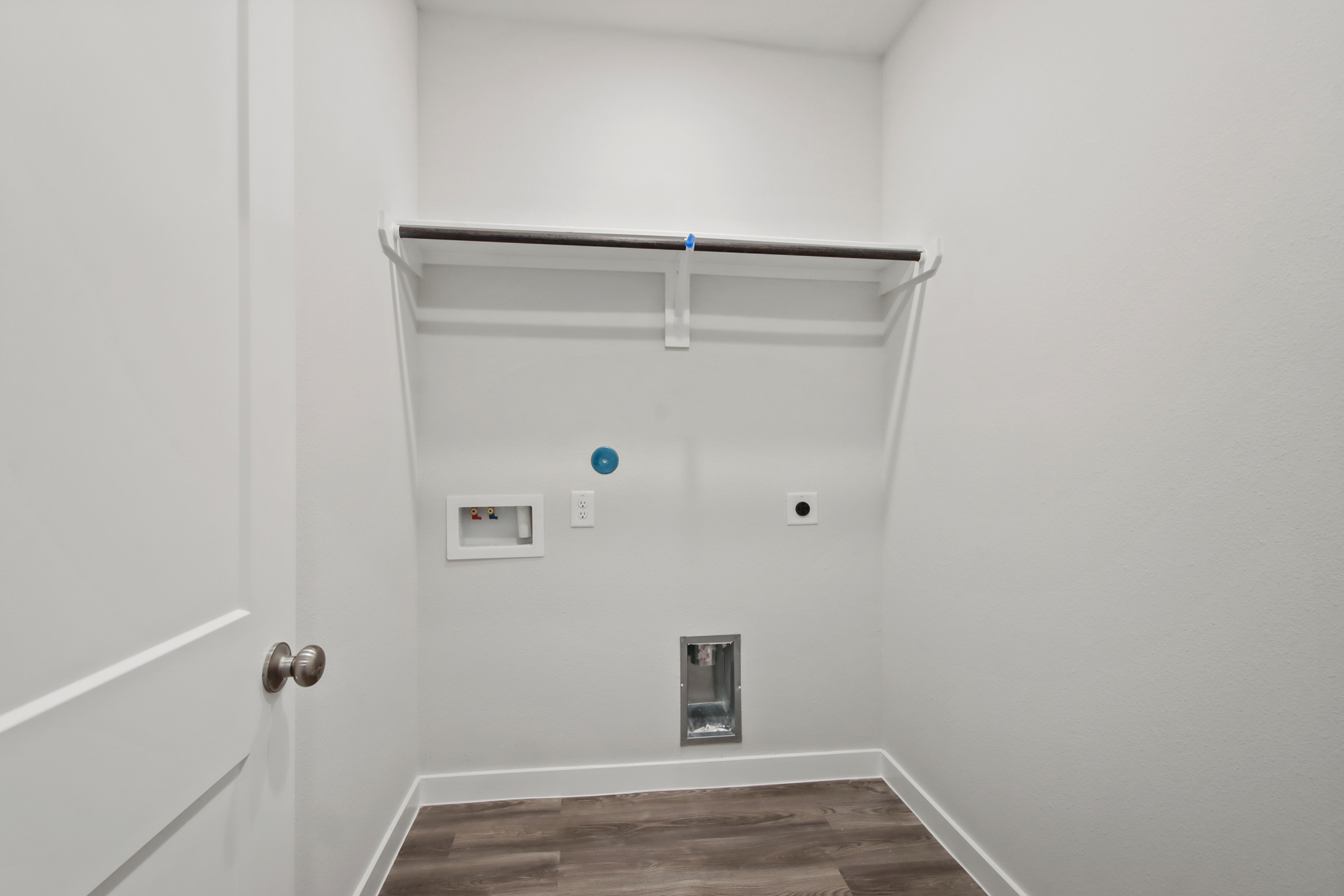 A white wall with a light fixture.