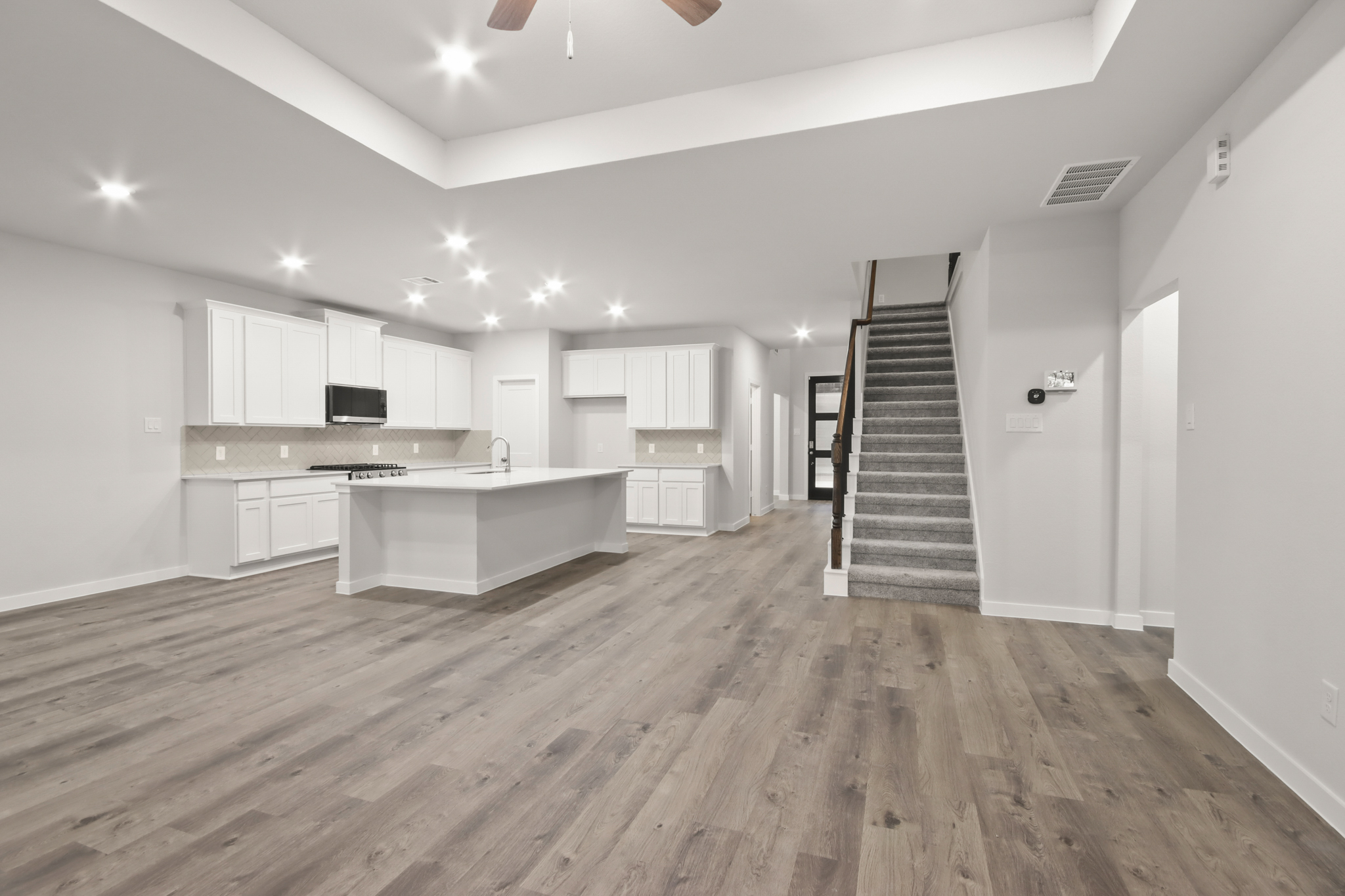 A large kitchen with white cabinets.