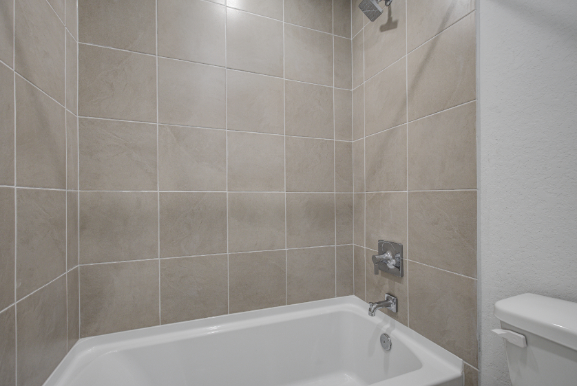 A bathroom with a bathtub and toilet.