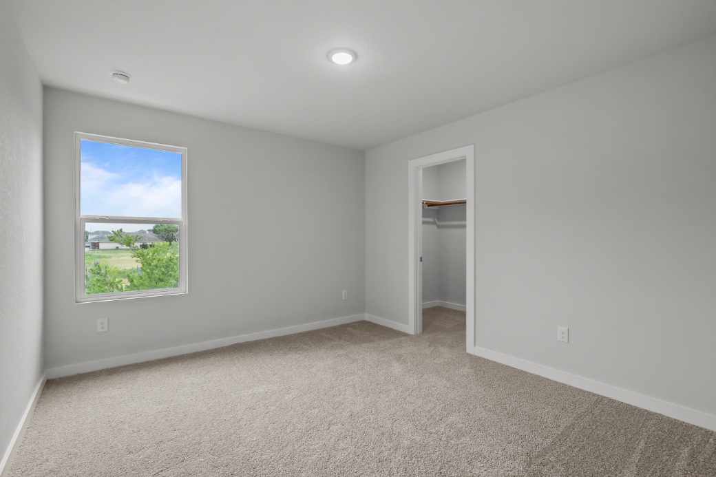 A room with a window and a door.