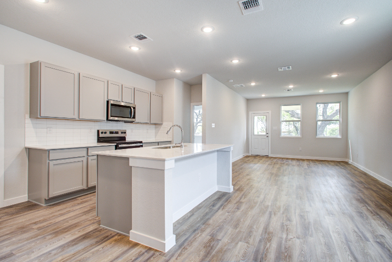 A kitchen with white cabinets.