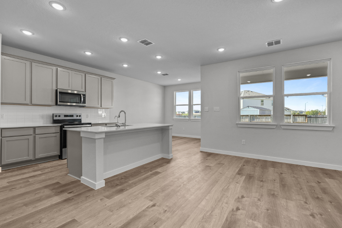 A kitchen with white cabinets.