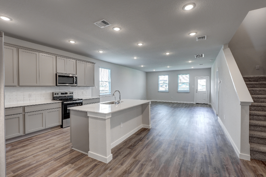 A kitchen with white cabinets.