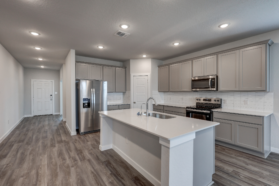 A kitchen with white cabinets.