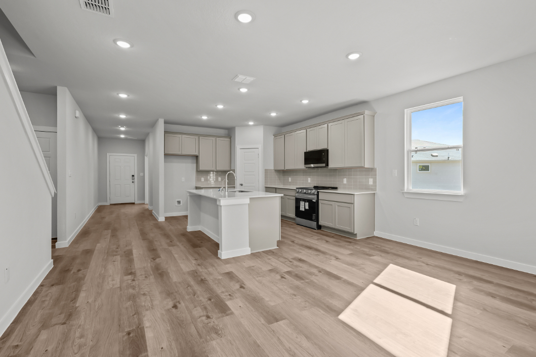 A kitchen with white cabinets.