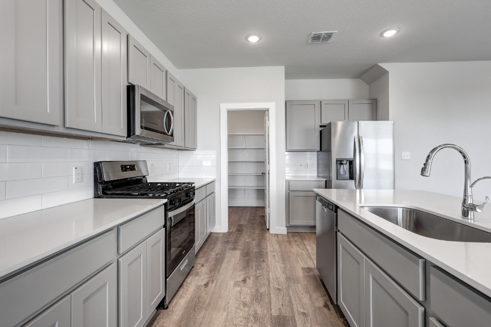 A kitchen with white cabinets.