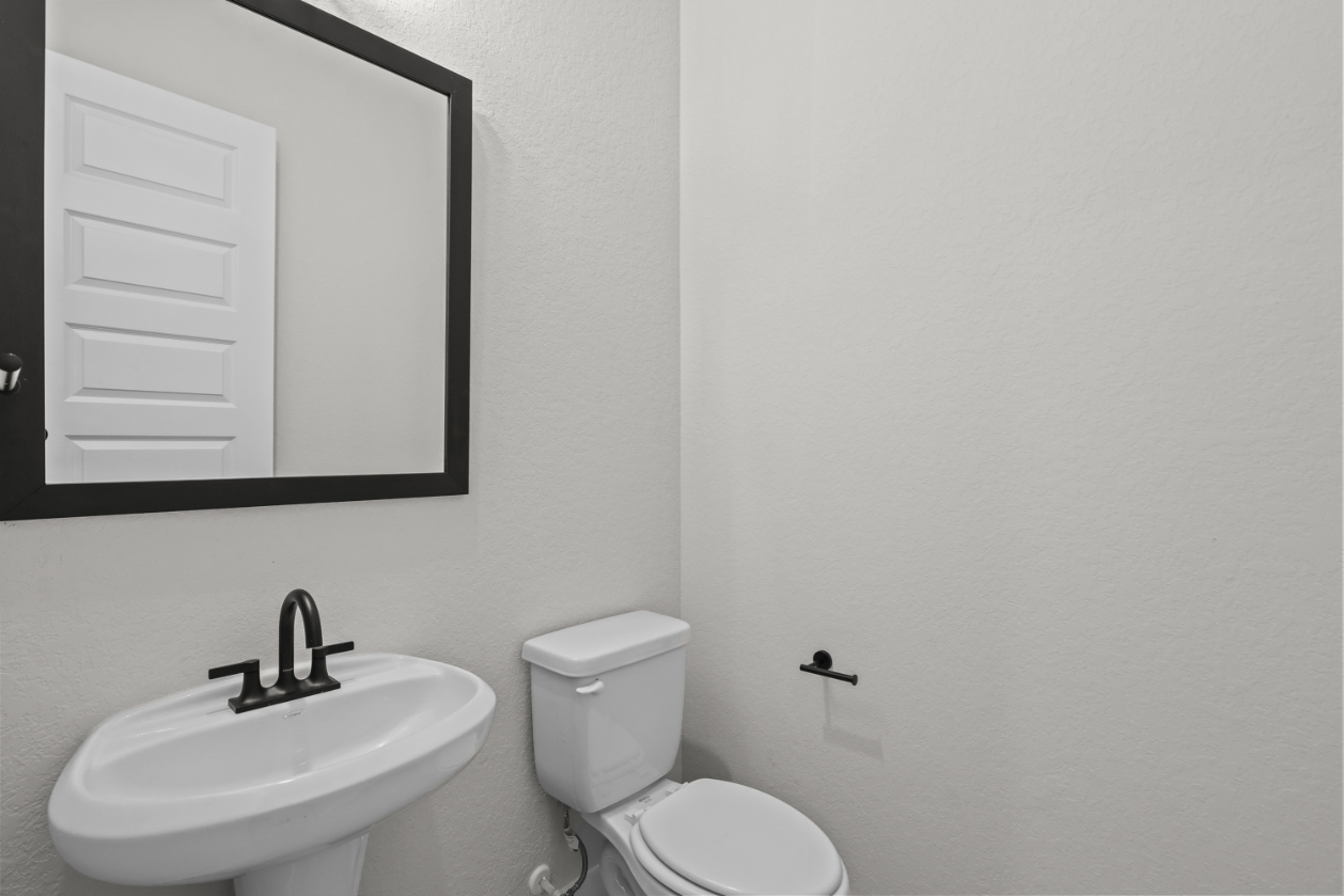 A bathroom with a sink and toilet.
