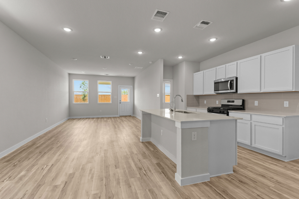 A kitchen with white cabinets.