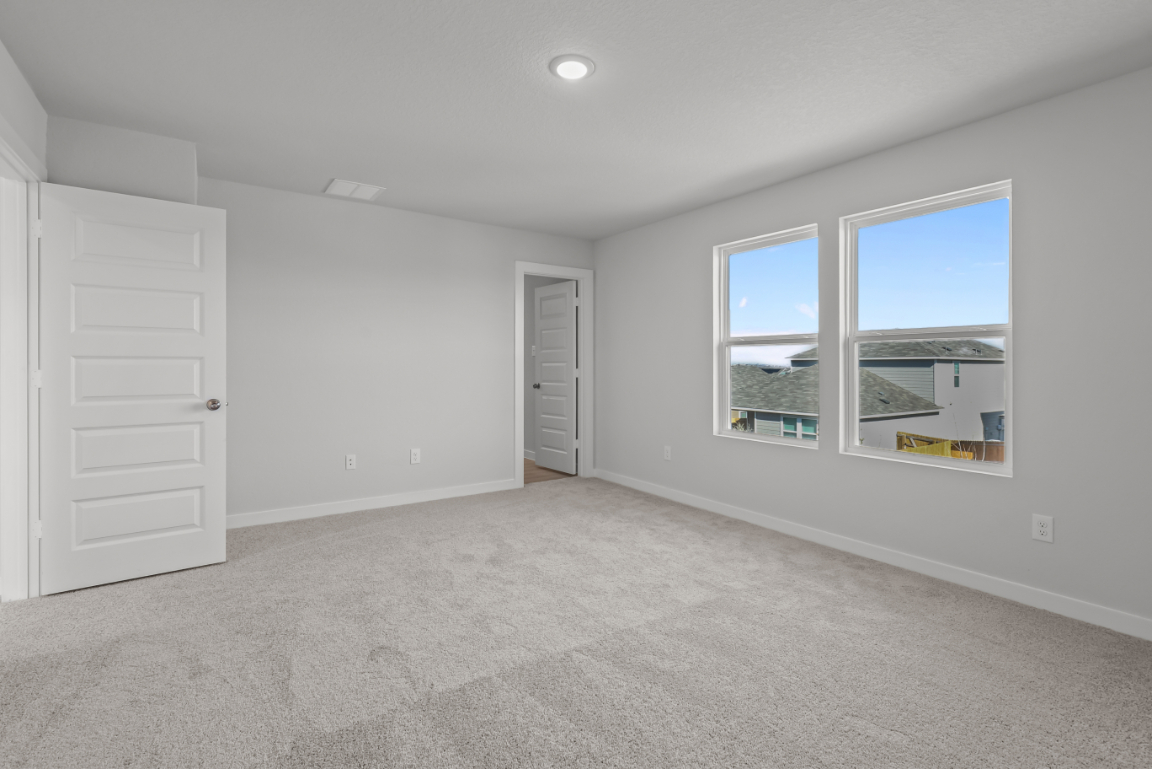 A room with white walls and a window.