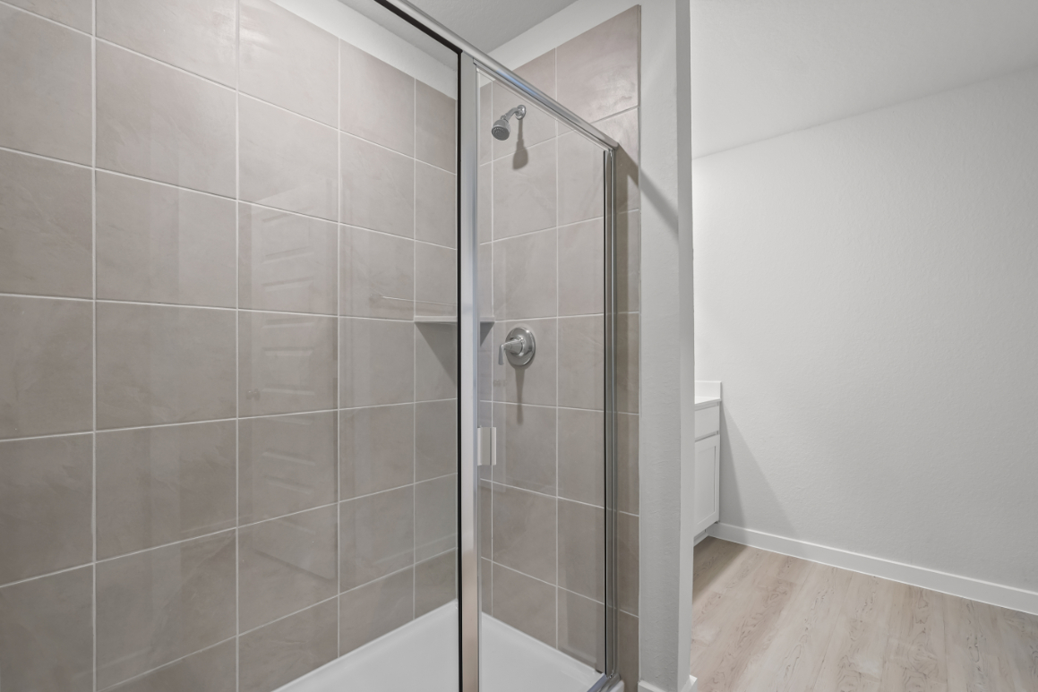 A shower with a glass door.