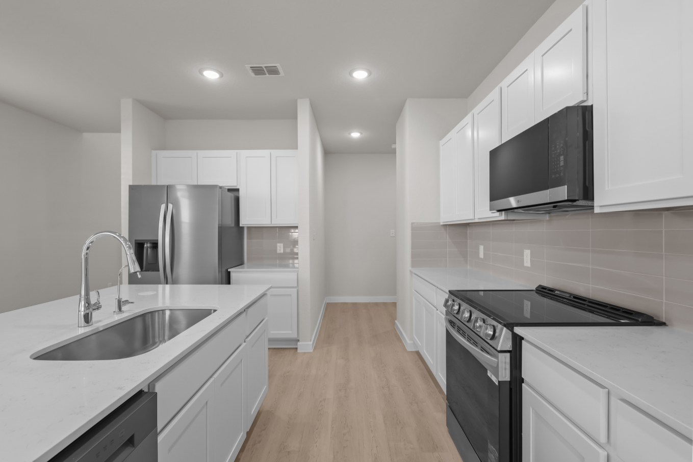 A kitchen with white cabinets.