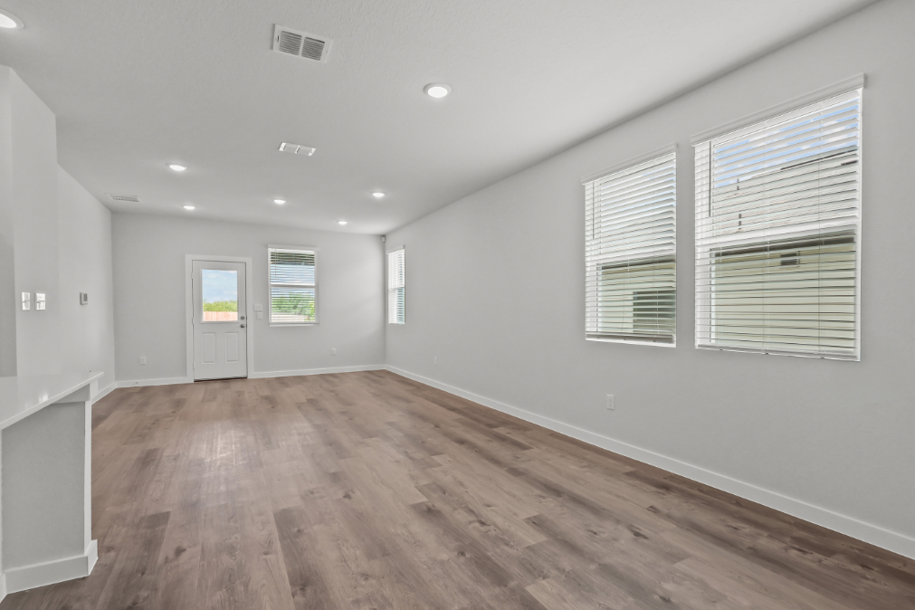 A room with a wood floor and white walls.