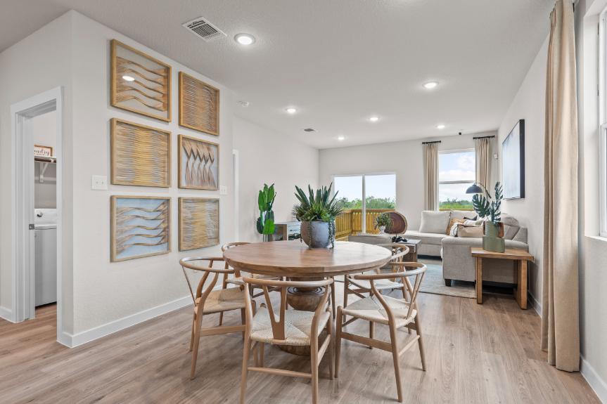 A room with a table chairs and a couch.